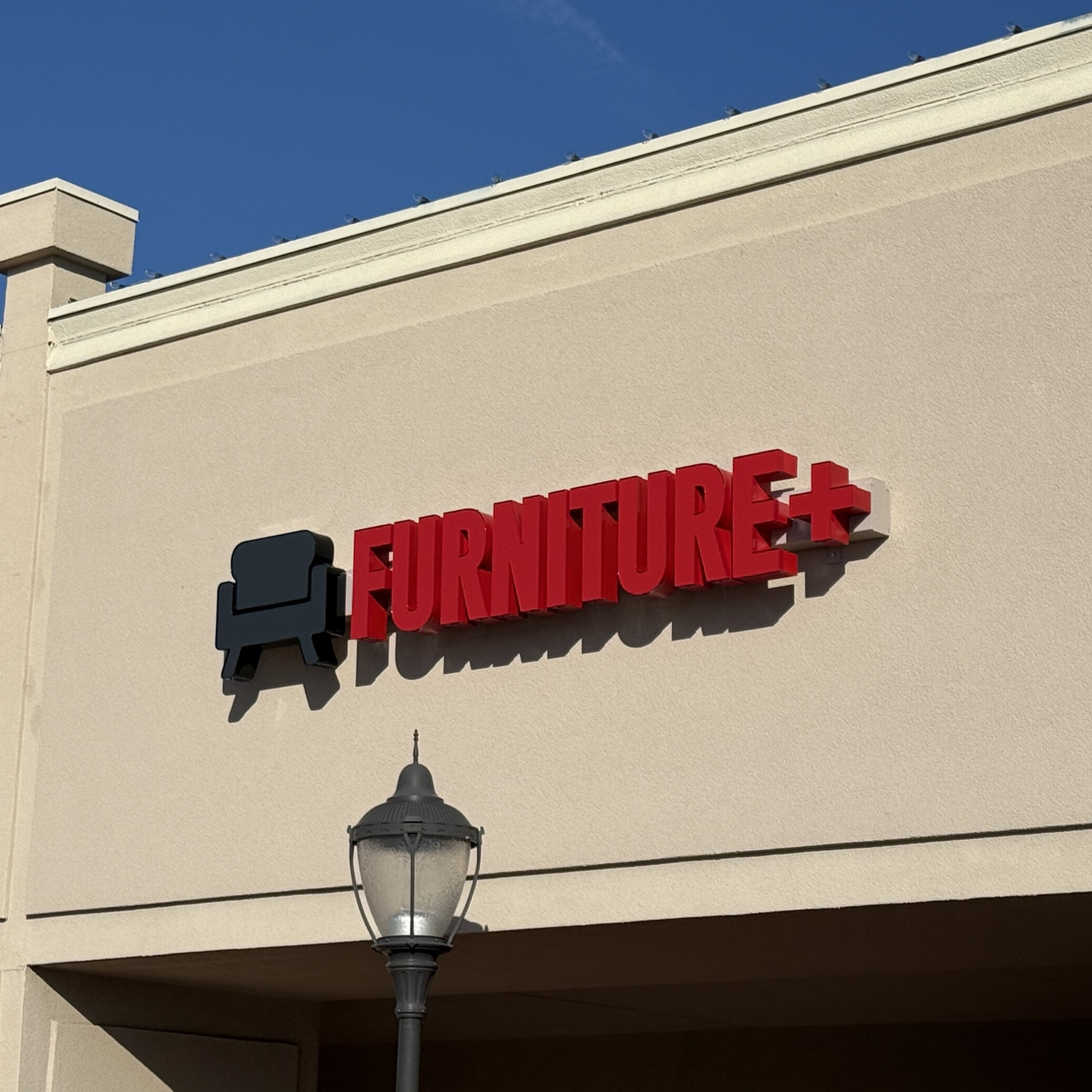 Illuminated channel letters on the Furniture Plus building exterior