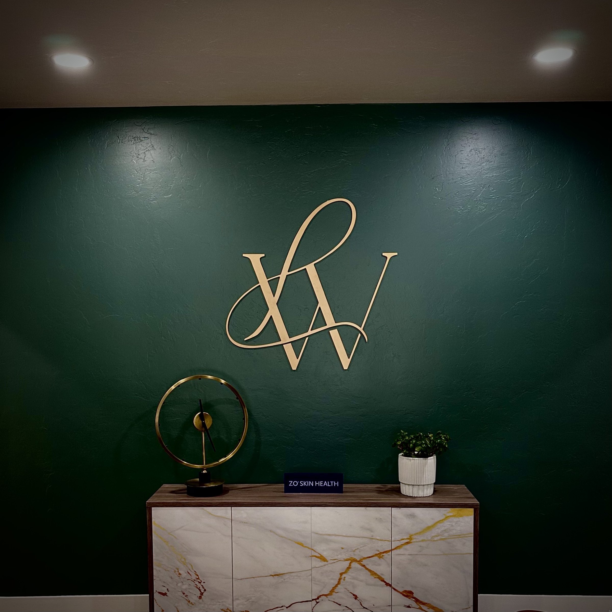 Dimensional metal logo on the Live Well reception feature wall