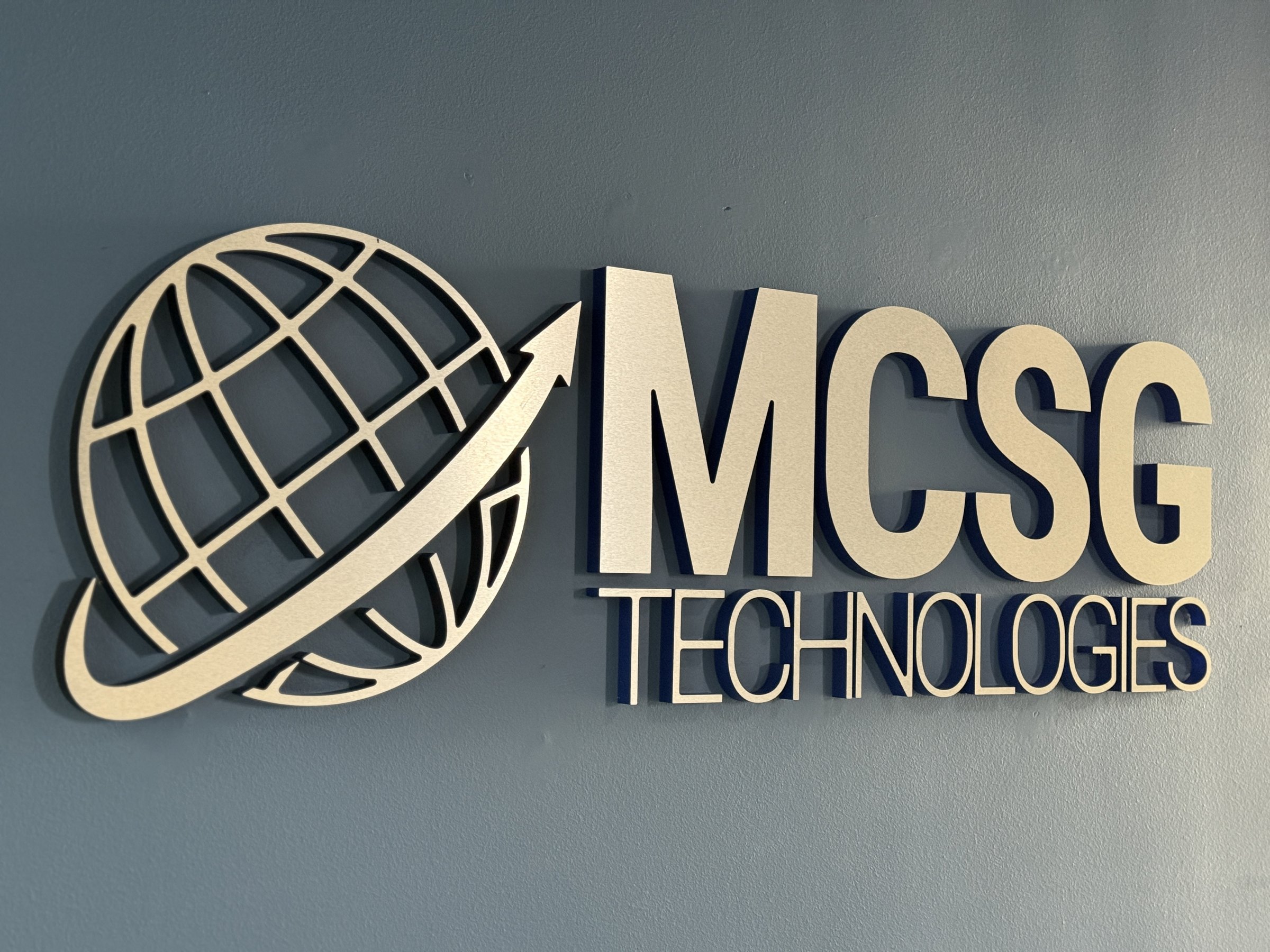 Brushed metal dimensional lettering and globe logo for MCSG Technologies