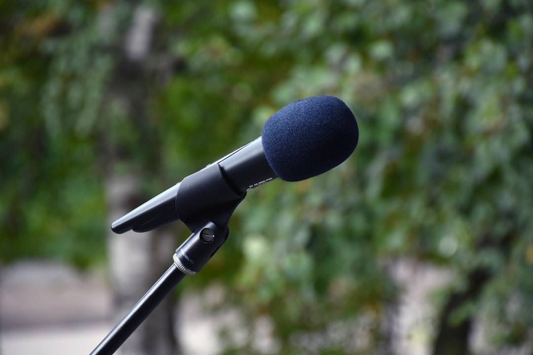 A professional PR agency director reviewing financial documents and pay structure charts on a laptop in a modern office.