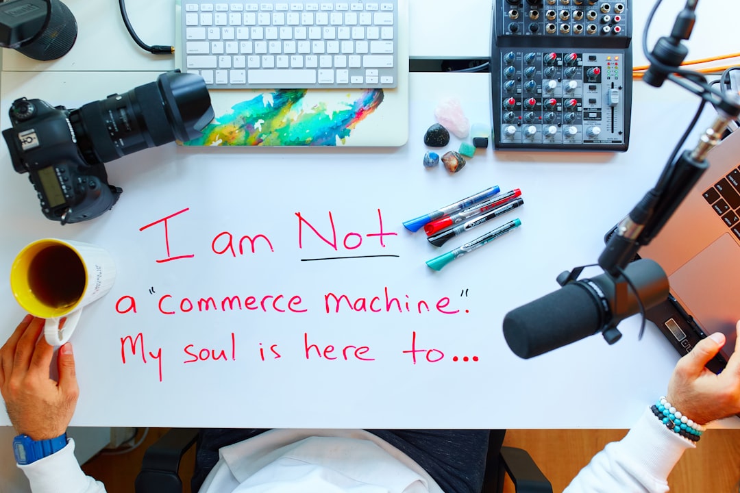 A modern digital marketing agency workspace with multiple computer screens displaying automated financial dashboards and data visualisations.