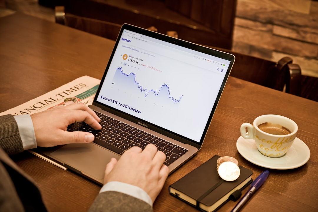 A modern AI agency office with financial charts on a screen, illustrating key finance trends for technology businesses.