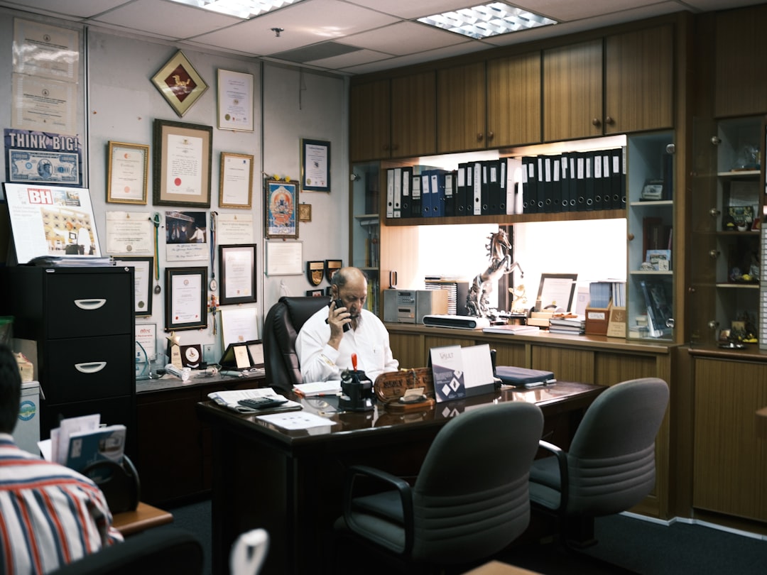 A professional agency desk with a serious-looking HMRC investigation letter, a laptop, and organised financial documents, representing the need for a calm, structured response.