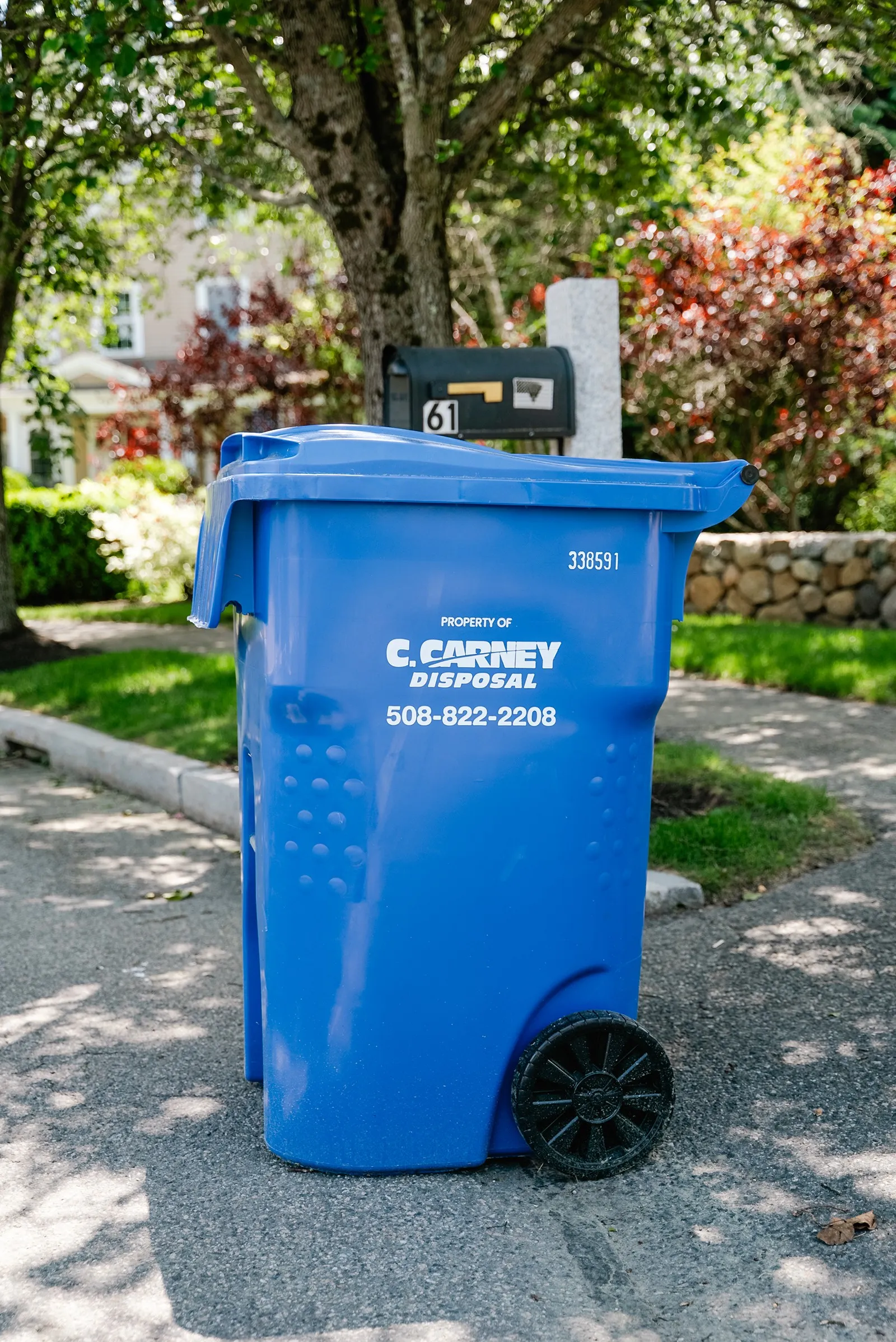 Carney Disposal trash truck servicing a neighborhood route