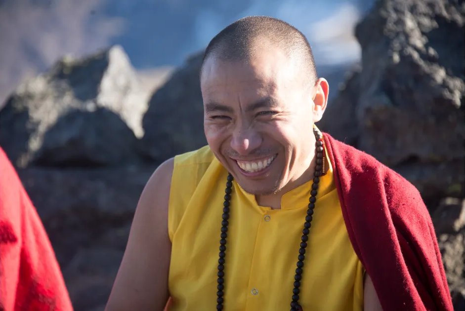 Portrait of Drupon Lama Dorje smiling in the mountains