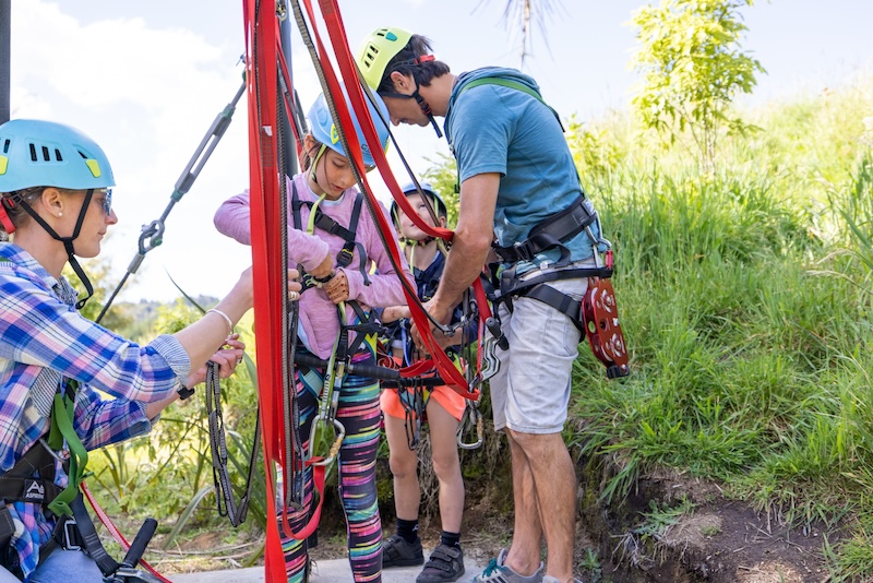 Guest securely harnessed before ziplining in Rotorua