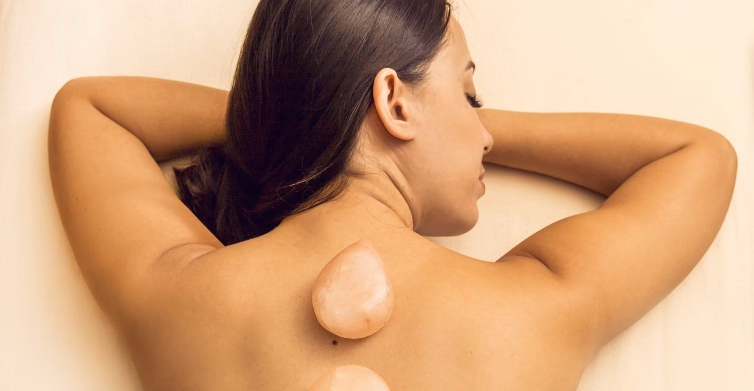 Woman with salt stones on back