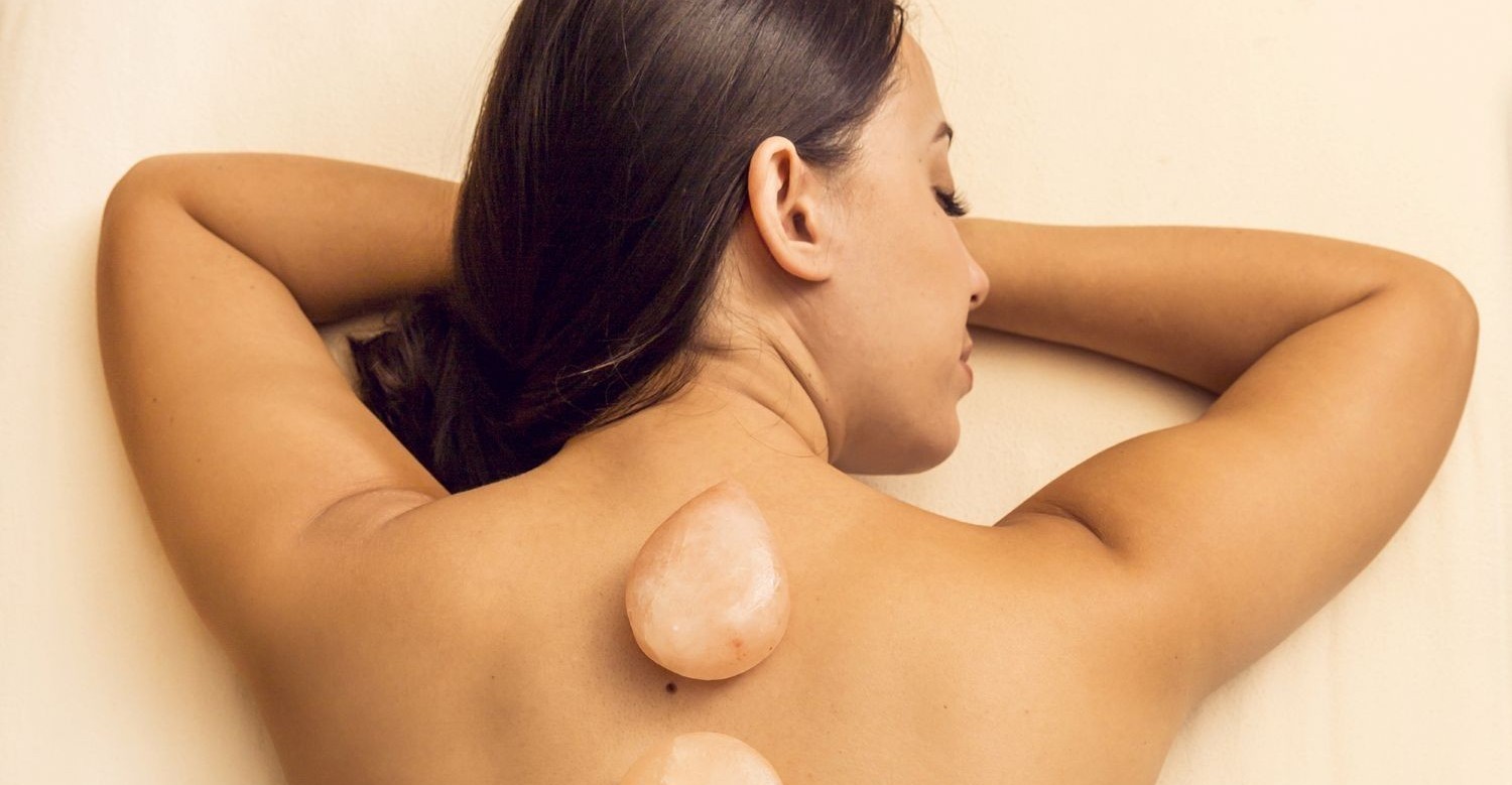 Woman with salt stones on back