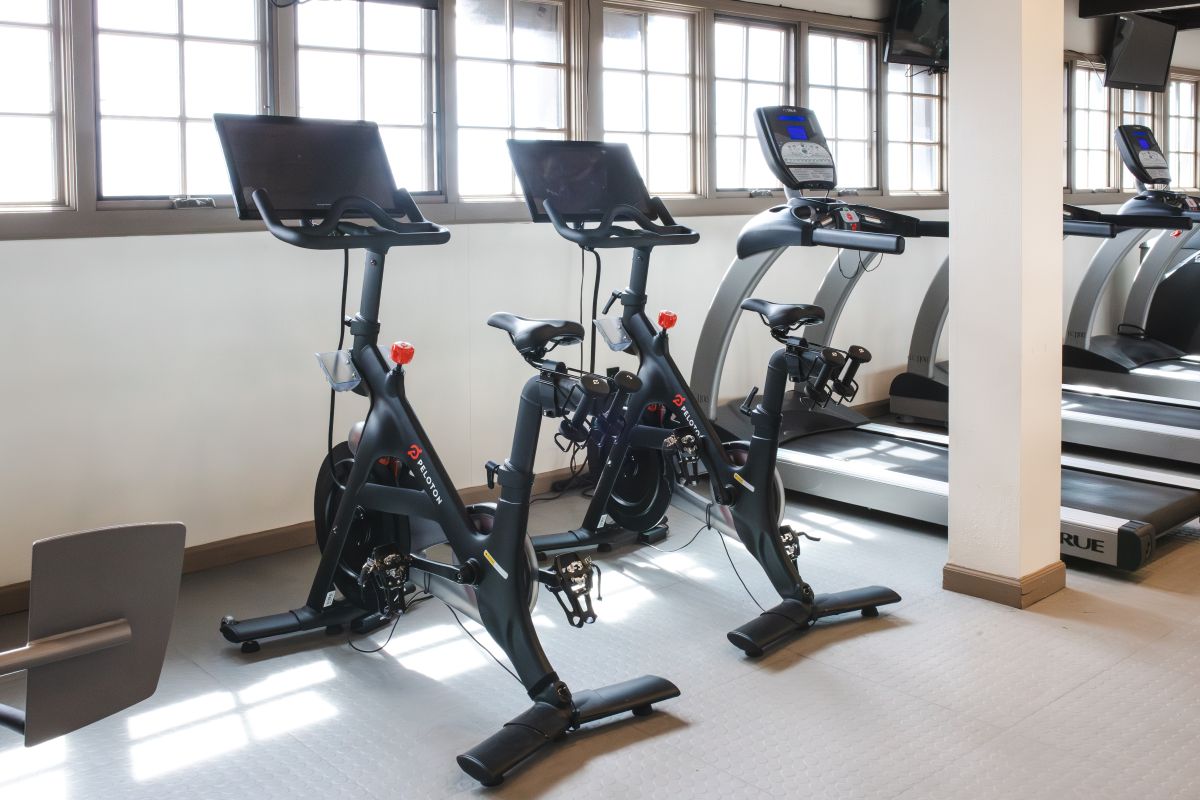 Various exercise equipment in fitness center to include Peloton bikes