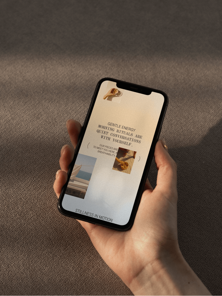 A hand holding an Iphone with Lunasol mobile website on screen