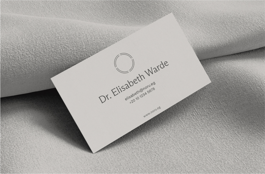 A Noru business card on a white textile