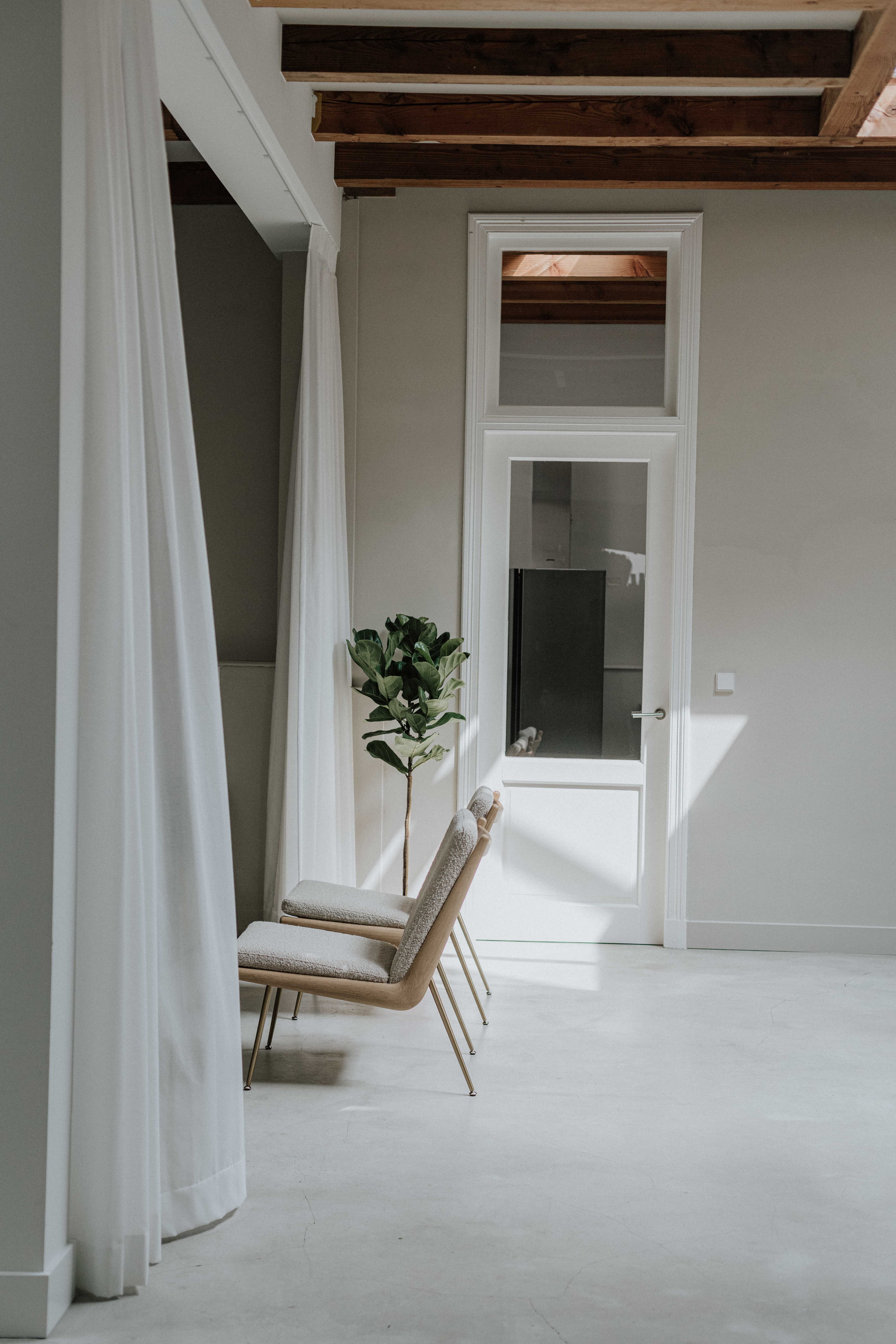 A bright room, with designer x
chairs and curtains