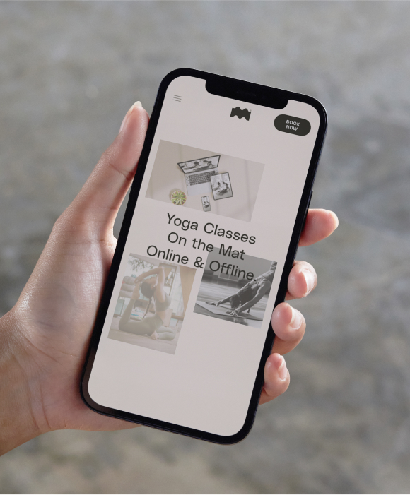 A hand holding an iPhone with Life on the mat website