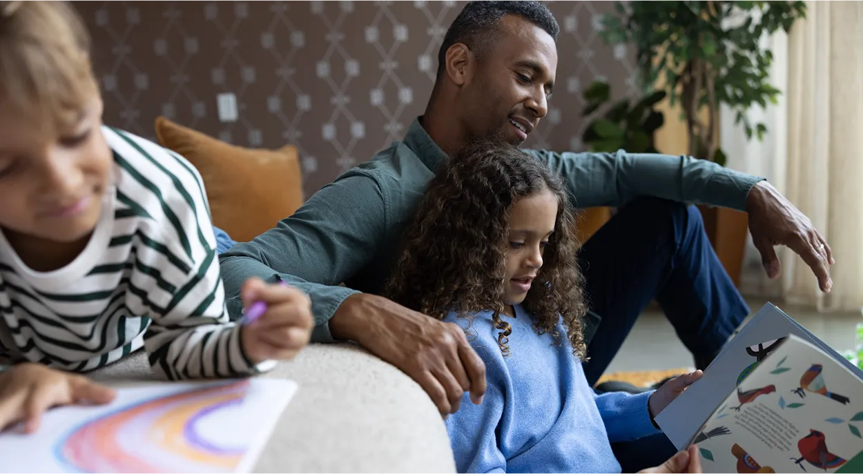 Family looking at a book