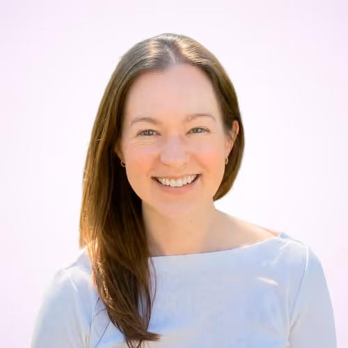 Angie Voyles Askham, PhD headshot on a light pink background