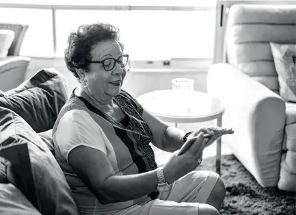 Women on sofa smiling at her smartphone