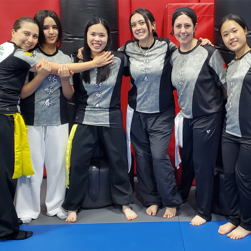 Instructor tying belt of a child student