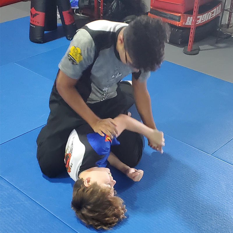 Instructor tying belt of a child student