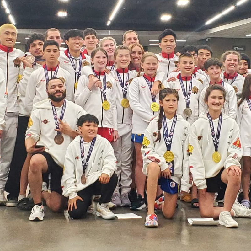 Instructor tying belt of a child student
