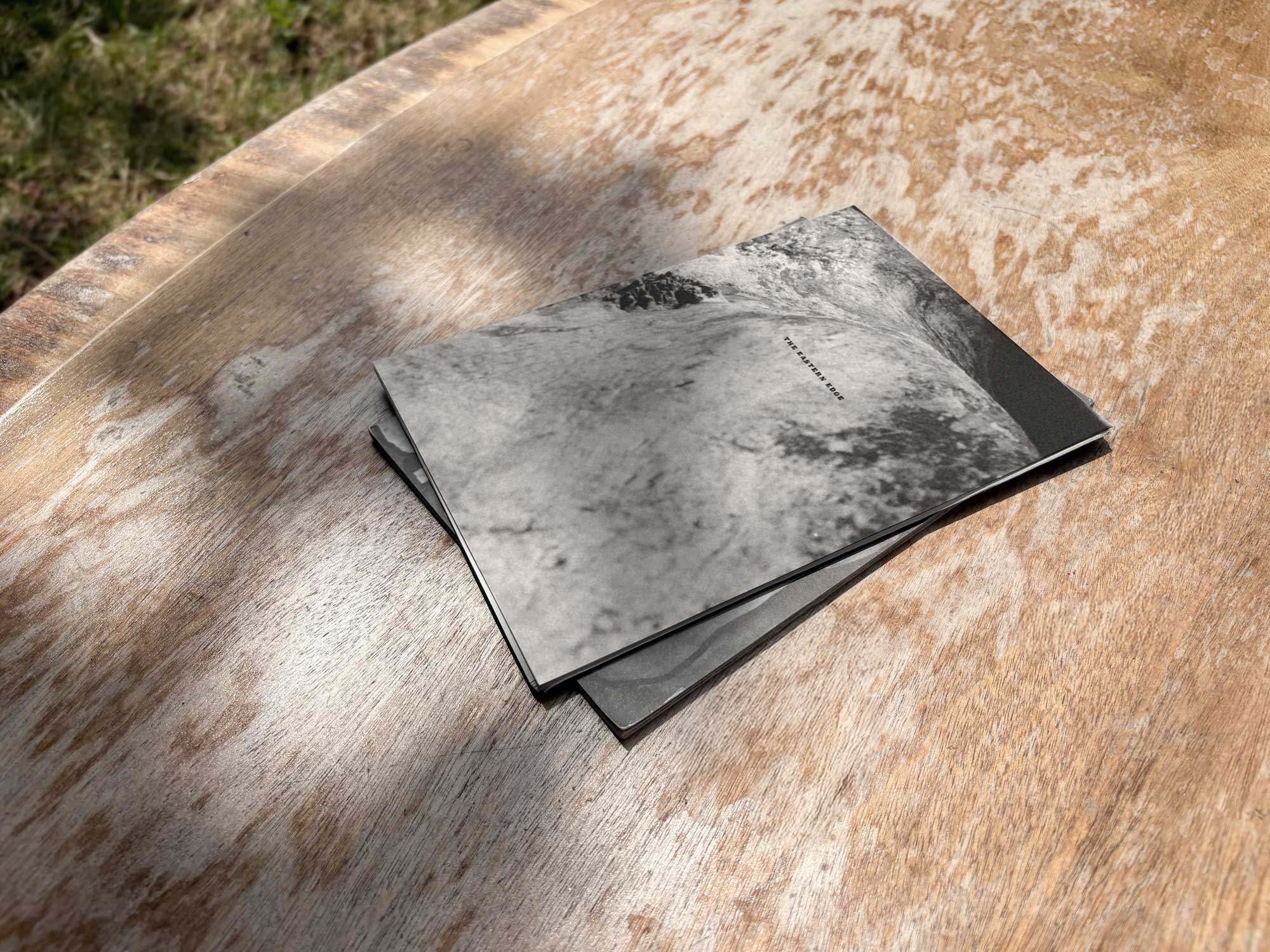 The Eastern Edge booklet on an outdoor table-top.