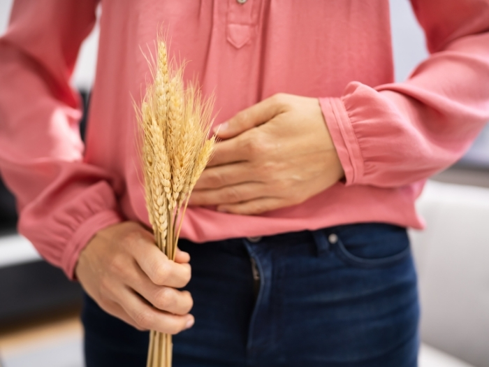 woman holding wheat and belly