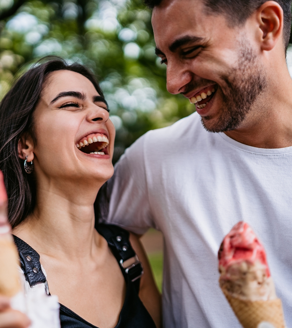 happy man and woman eating ice cream