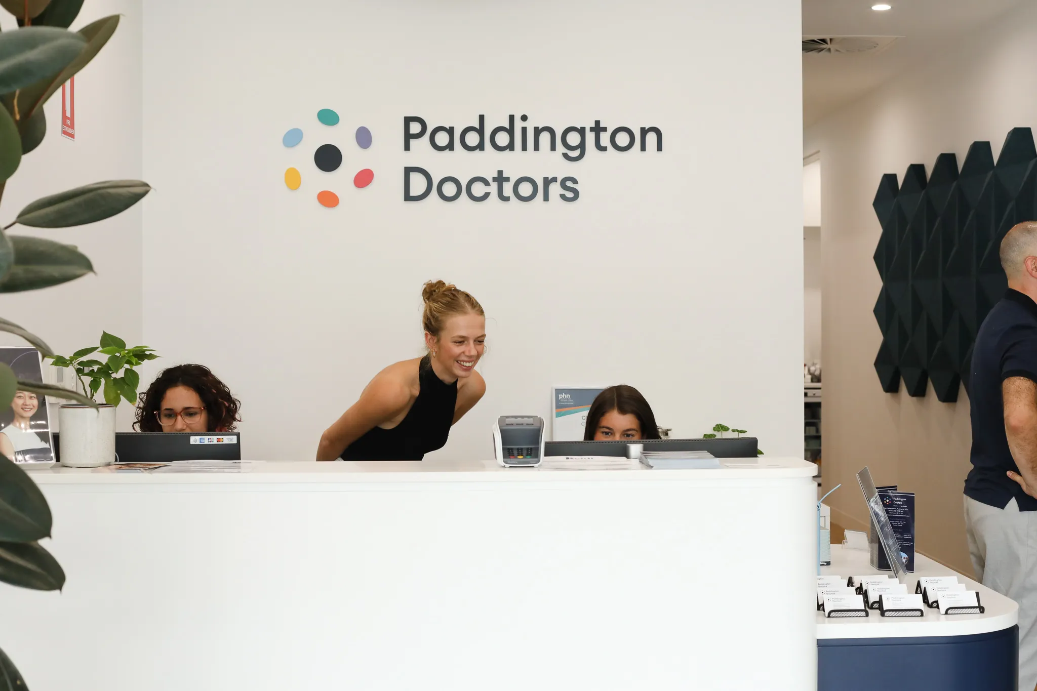Paddington doctors team in the reception area smiling