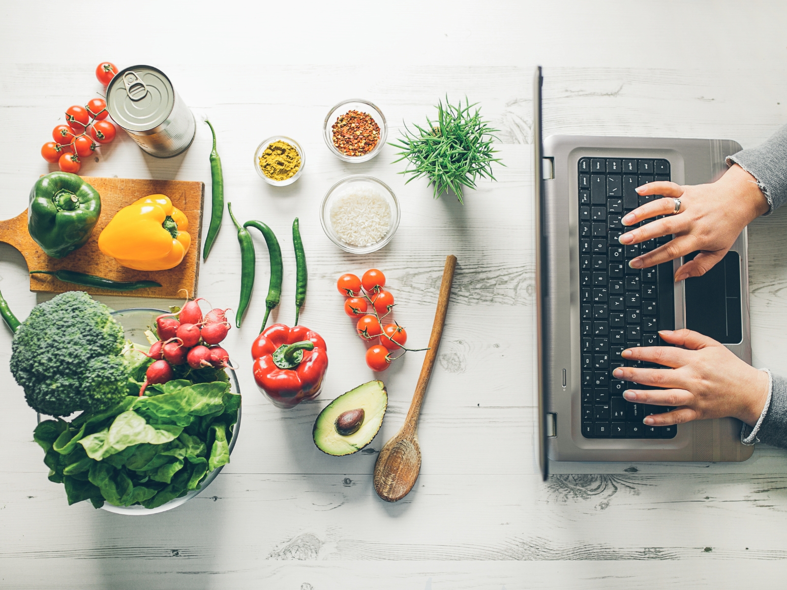 searching on computer looking for gluten-free recipe with gluten-free ingredients on a counter
