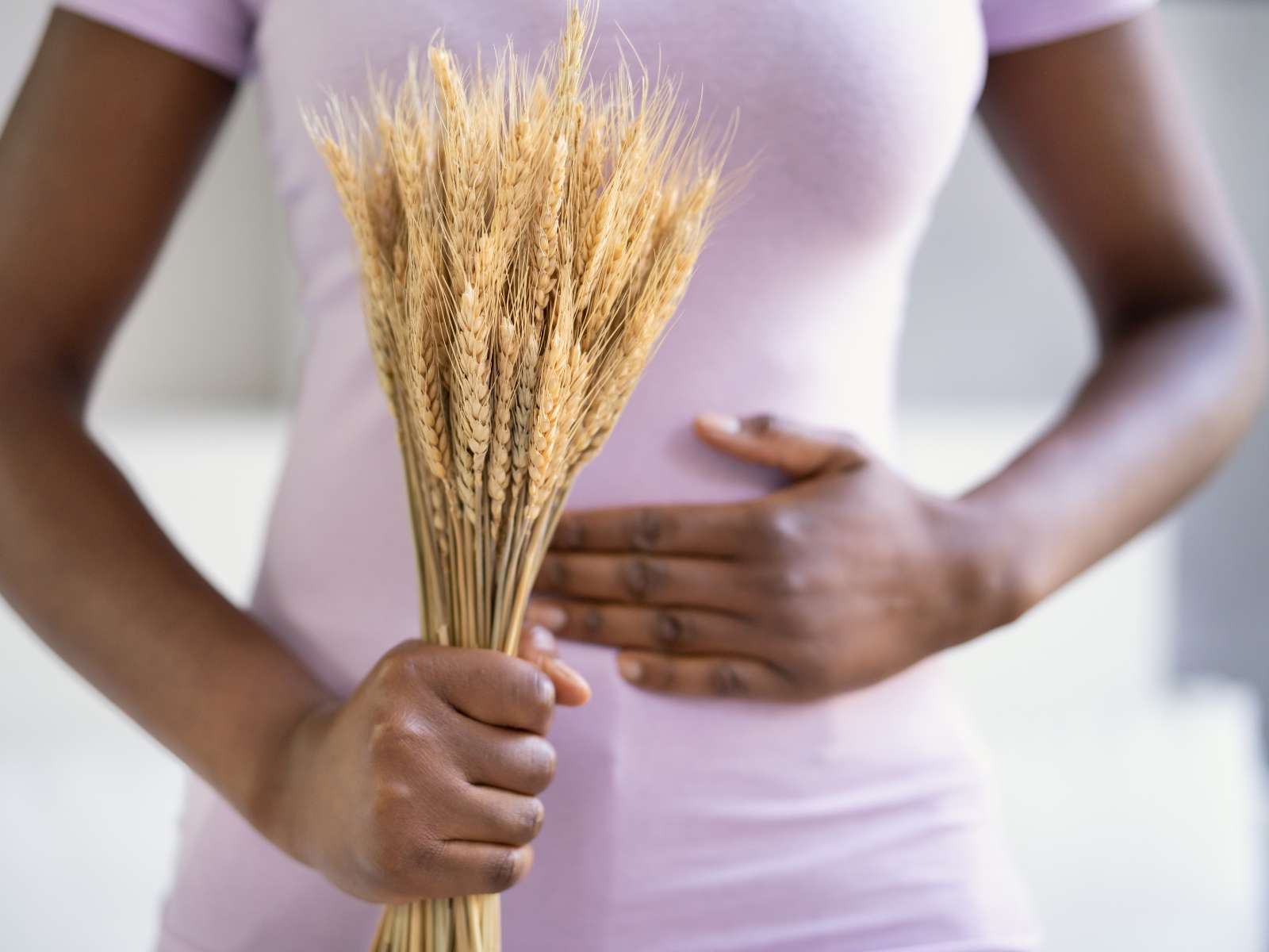 Person with gluten intolerance holding belly