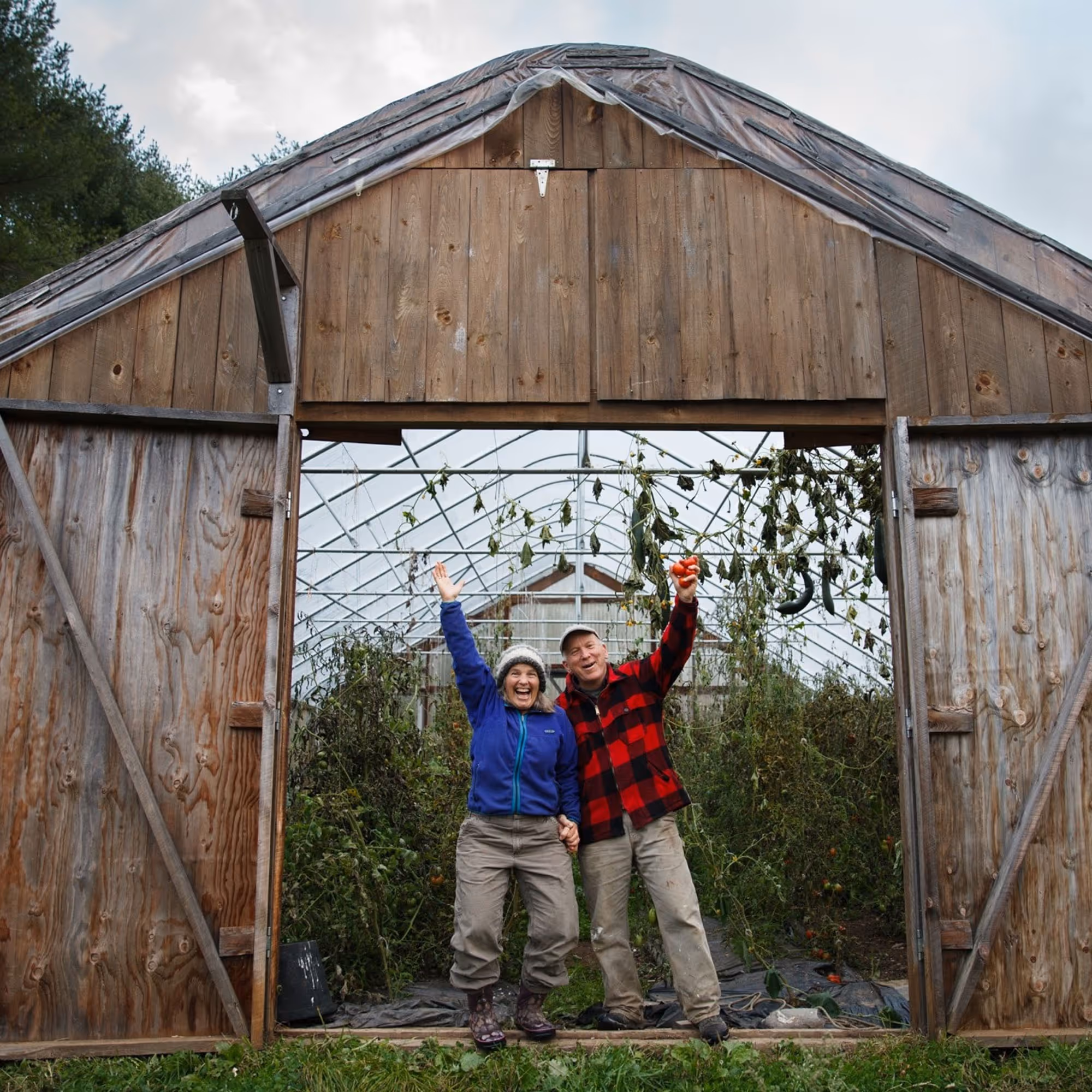 Happy couple celebrating in front of a greenhouse