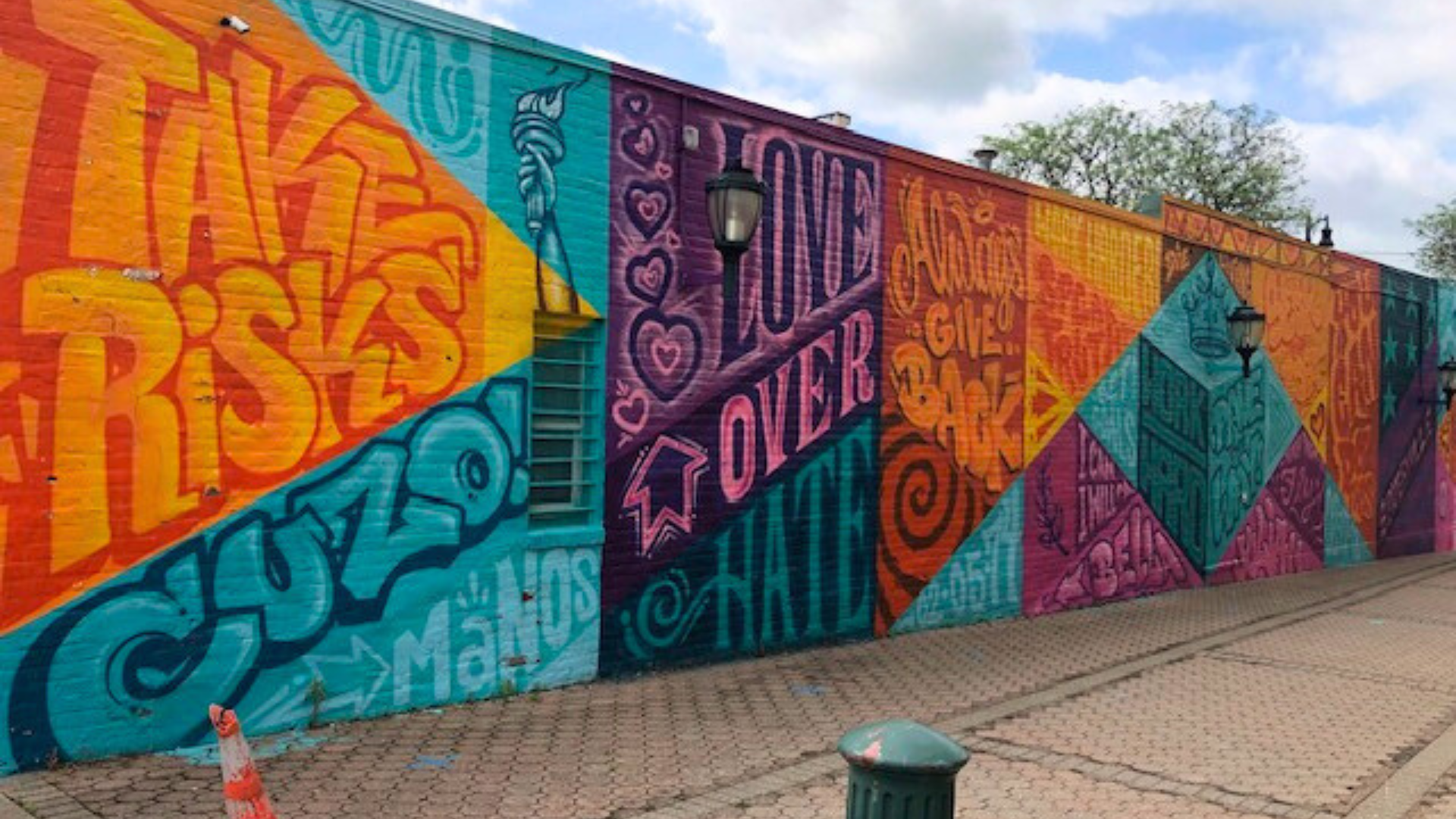 Red spray-painted chalk outline of a human body on a concrete surface.