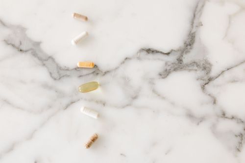 Dr. Margot ND blog on choosing a supplement. Photo includes 5 different supplements on a white marble counter — naturopathic care West End Toronto