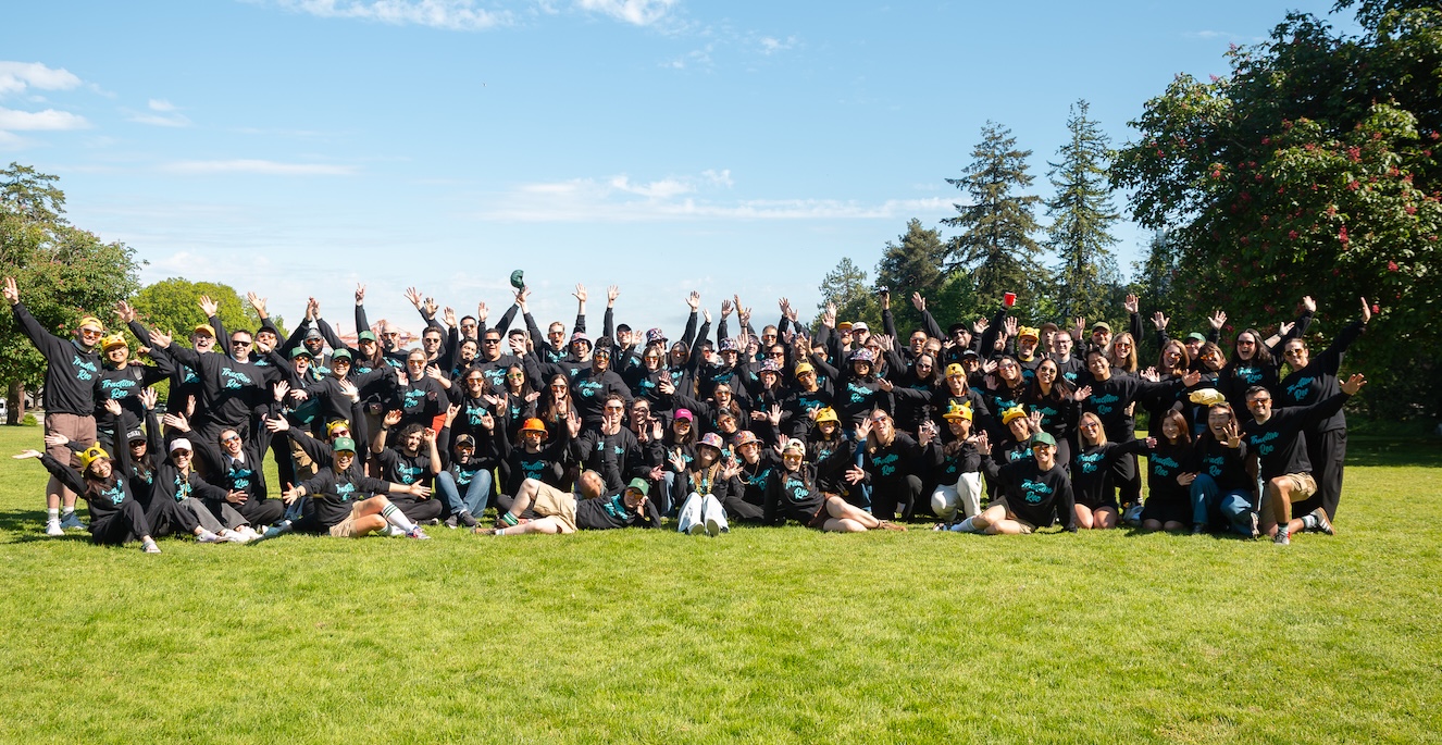 An image of a group of 100 happy and enthusiastic adults in a park setting
