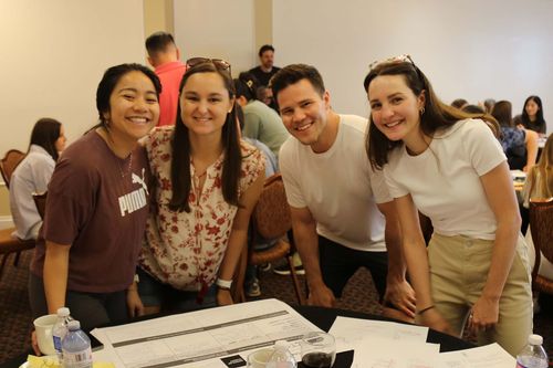 4 people smiling at the camera