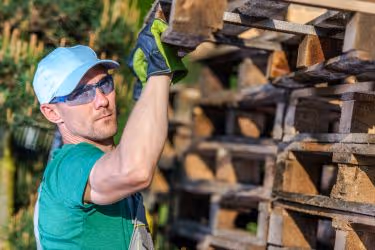 Man transporting pallets.