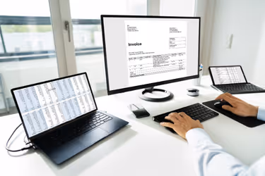 Man looking at invoices on the computer