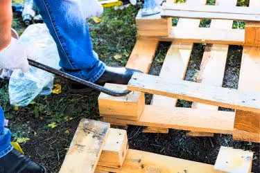 Man disassembling an old pallet