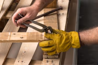 Man repairing a wooden pallet.