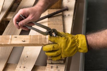 Man repairing a wooden pallet.