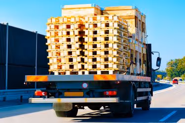 Truck carrying many pallets.