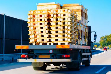 Truck carrying many pallets.