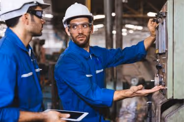 Man teaching another how to use the machine