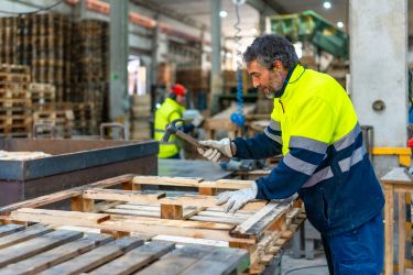 Man working on repairing a wood pallet