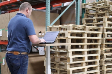 Man in a warehouse looking for pallet suppliers