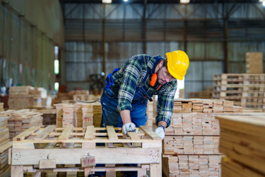 single man working on building pallets