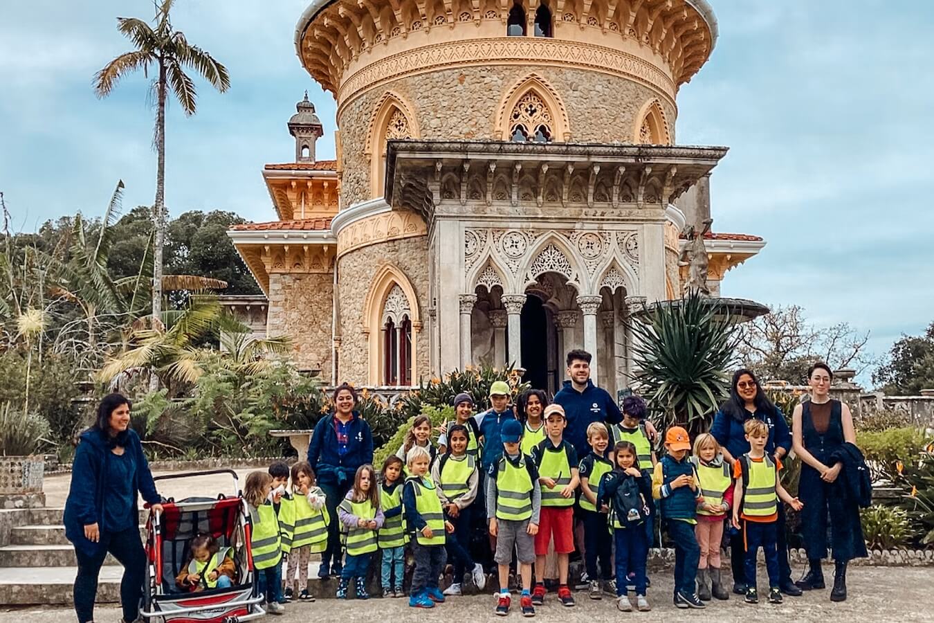 Boundless Life educators and children gathered in front of a beautiful building 