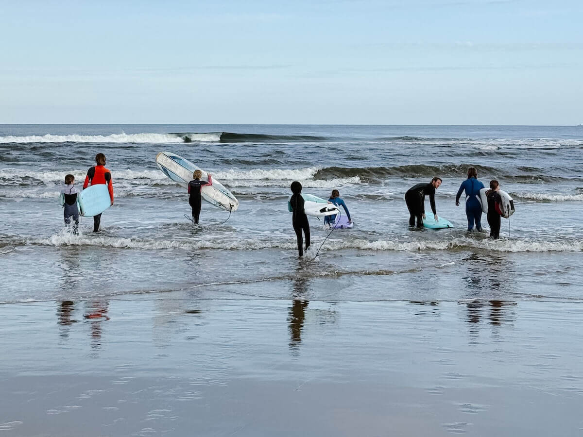 A group from Boundless Life go for a surfing lesson in La Barra Uruguay - Travel Family Guide