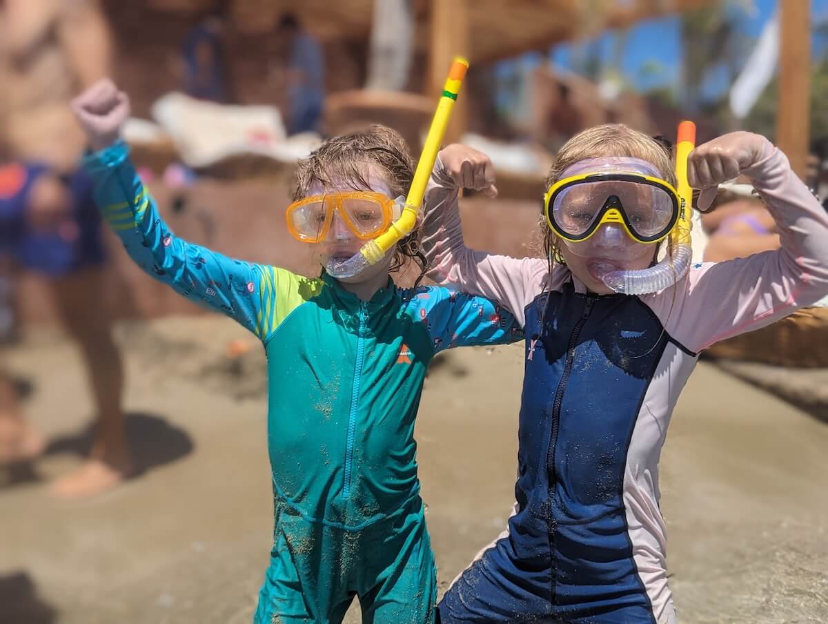 Kids from a large travel family dressed for the sea