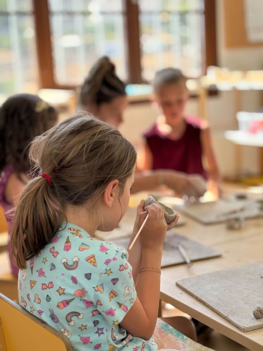 A child participates in a pottery class with Boundless Life