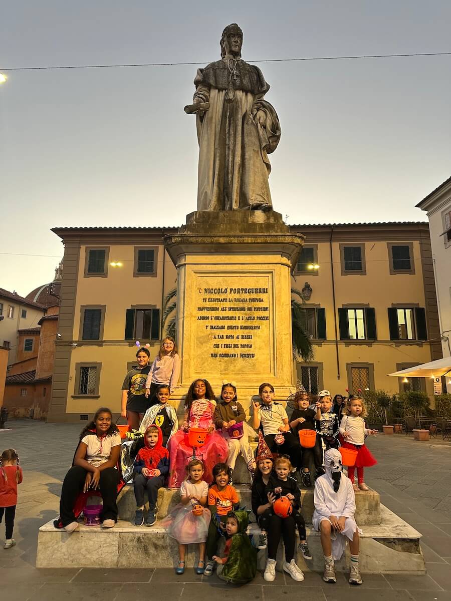 The Boundless Life community stand around a statue in Pistoia on an early evening gathering.